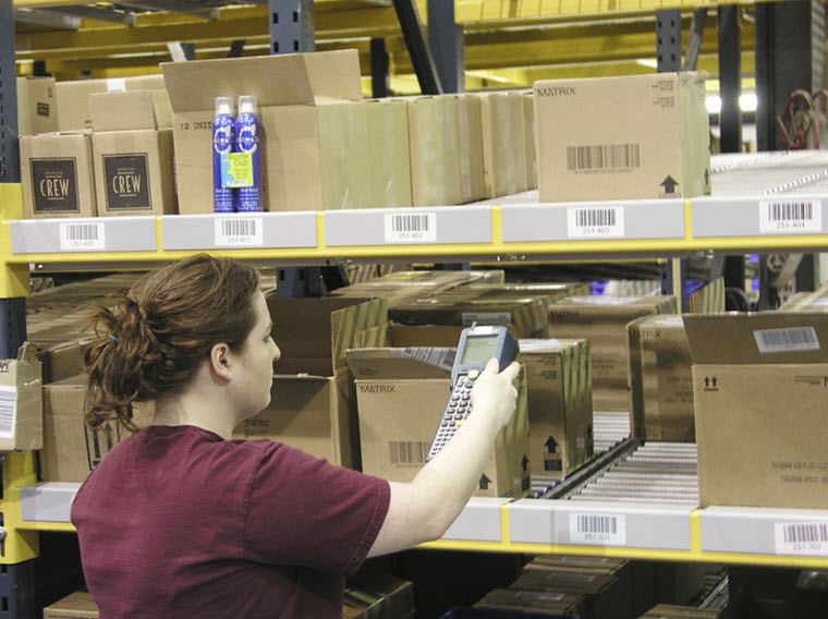 Woman putting packages in and out of storage