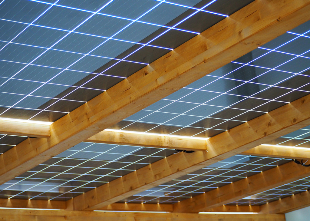 Wood/steel solar carport system with transparent solar modules